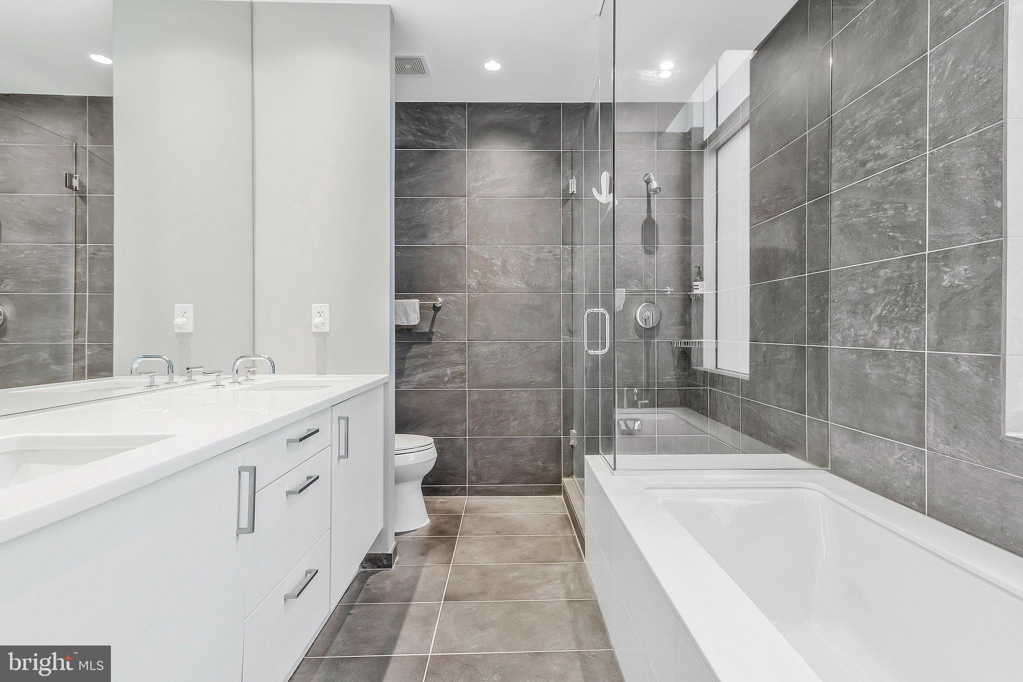 1177 22nd Street Northwest, Unit 2D Washington, DC 20037 - Photo 26 of 29 a spacious bathroom with a bathtub sink and toilet