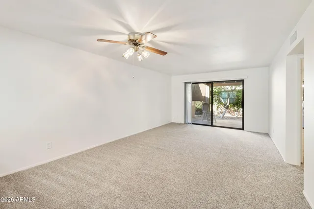 a kitchen with stainless steel appliances granite countertop a sink window and cabinets