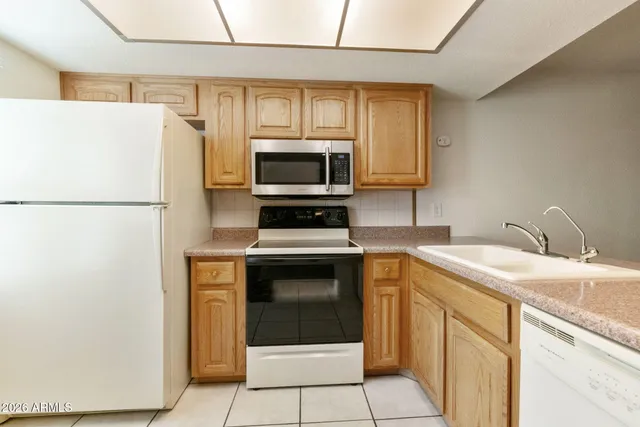a living room with furniture a rug and a flat screen tv