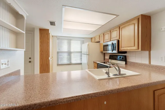 an empty room with a ceiling fan and a window
