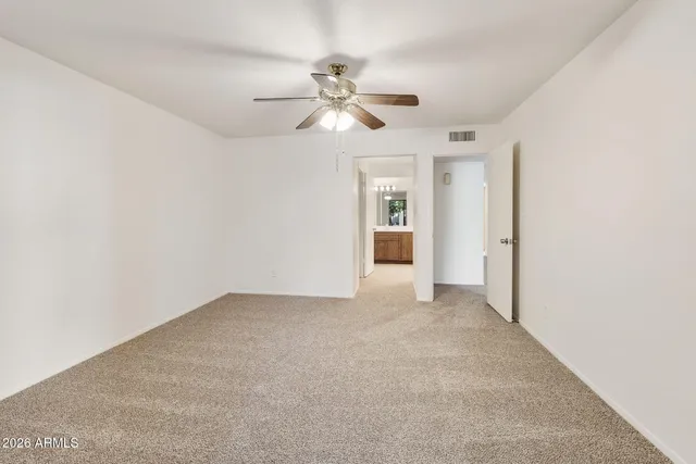 a spacious bathroom with a granite countertop sink a mirror and a shower
