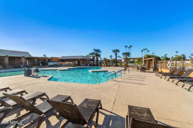 a view of swimming pool with outdoor seating and city view