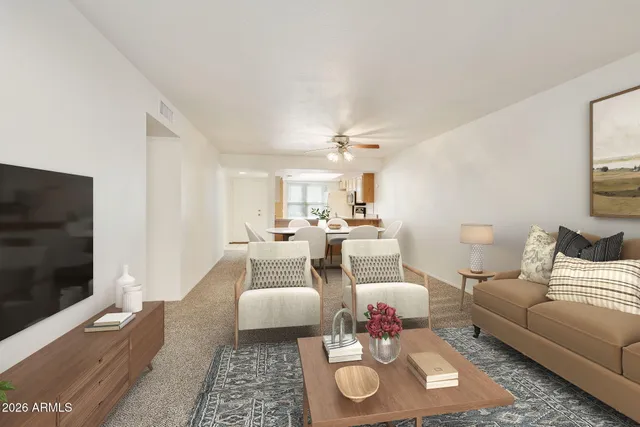 a spacious bedroom with a bed and potted plant