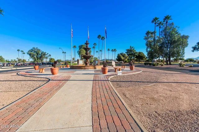 a view of a house with a big yard and big trees