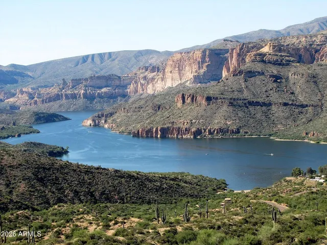 a view of a house with a mountain yard and a lake view