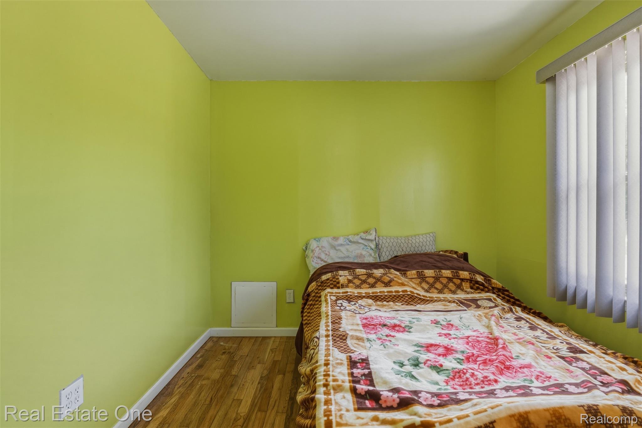 28151 Cherry Street Inkster, MI 48141 - Photo 5 of 18 Room featuring a window with vertical blinds, wood-finish flooring, and light green walls