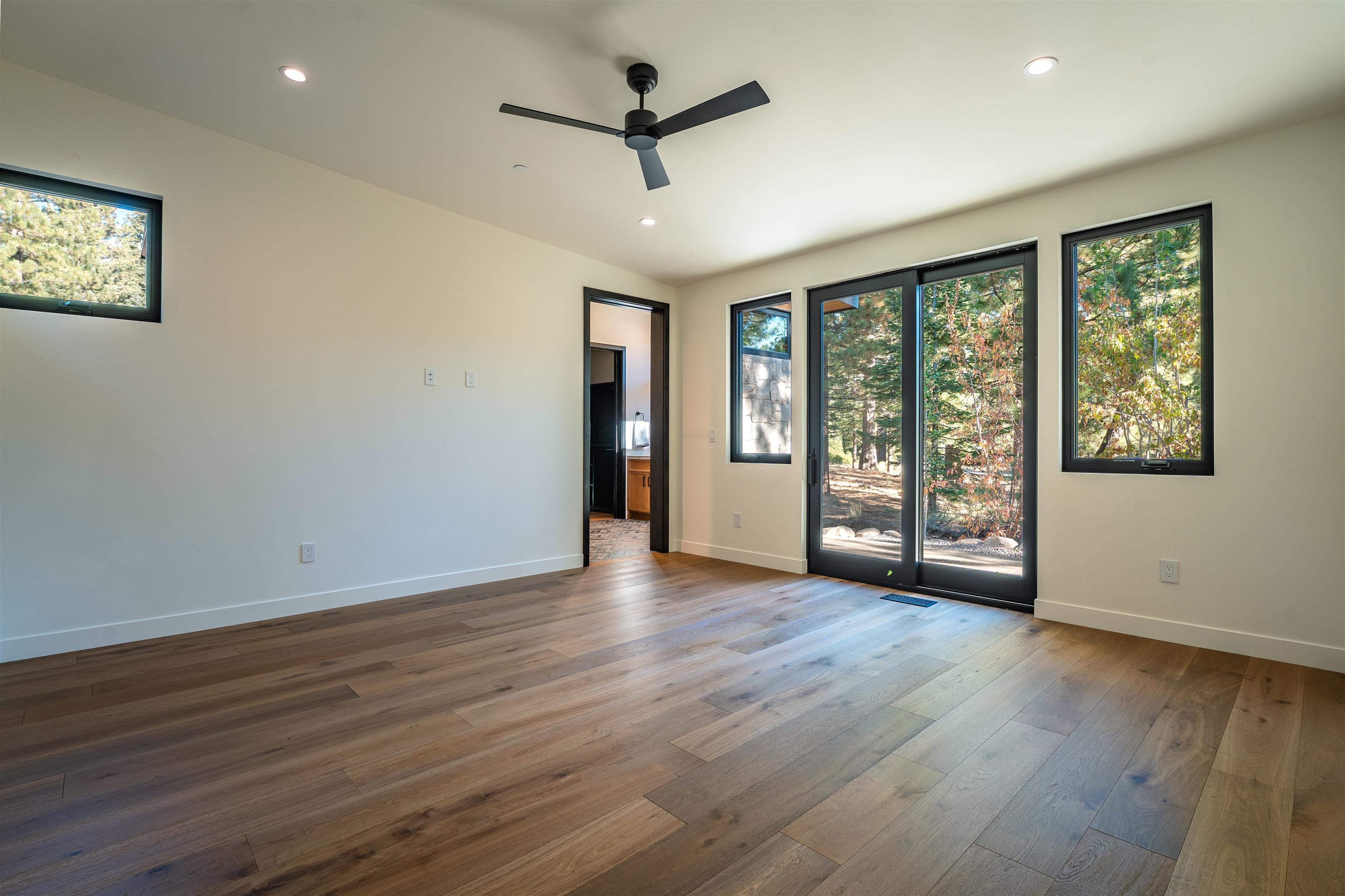 9090 Horned Lark Court Truckee, CA 96161 - Photo 11 of 28 a view of an empty room with a window and wooden floor