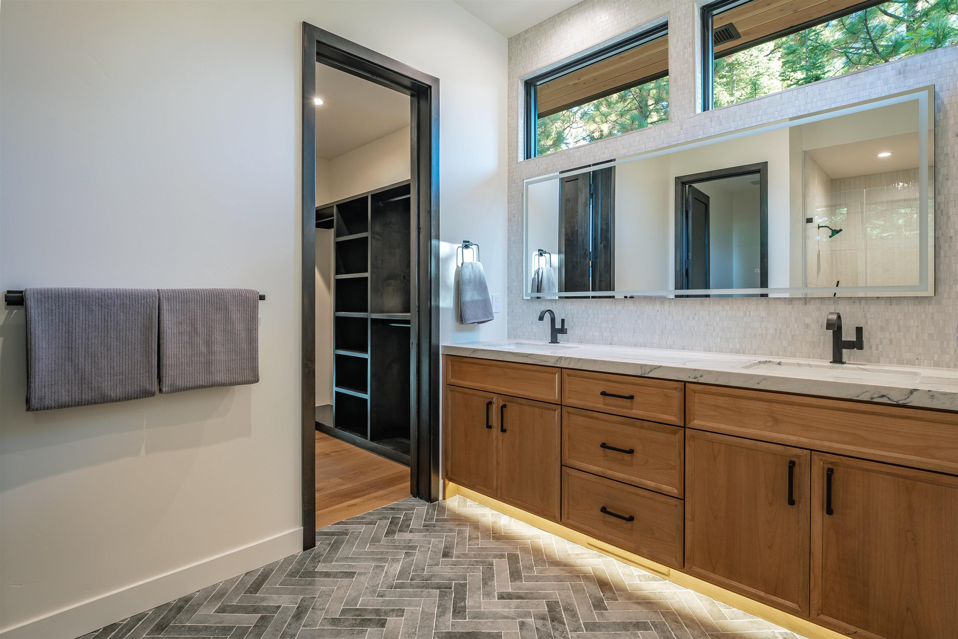 9090 Horned Lark Court Truckee, CA 96161 - Photo 12 of 28 a spacious bathroom with a double vanity sink and a mirror