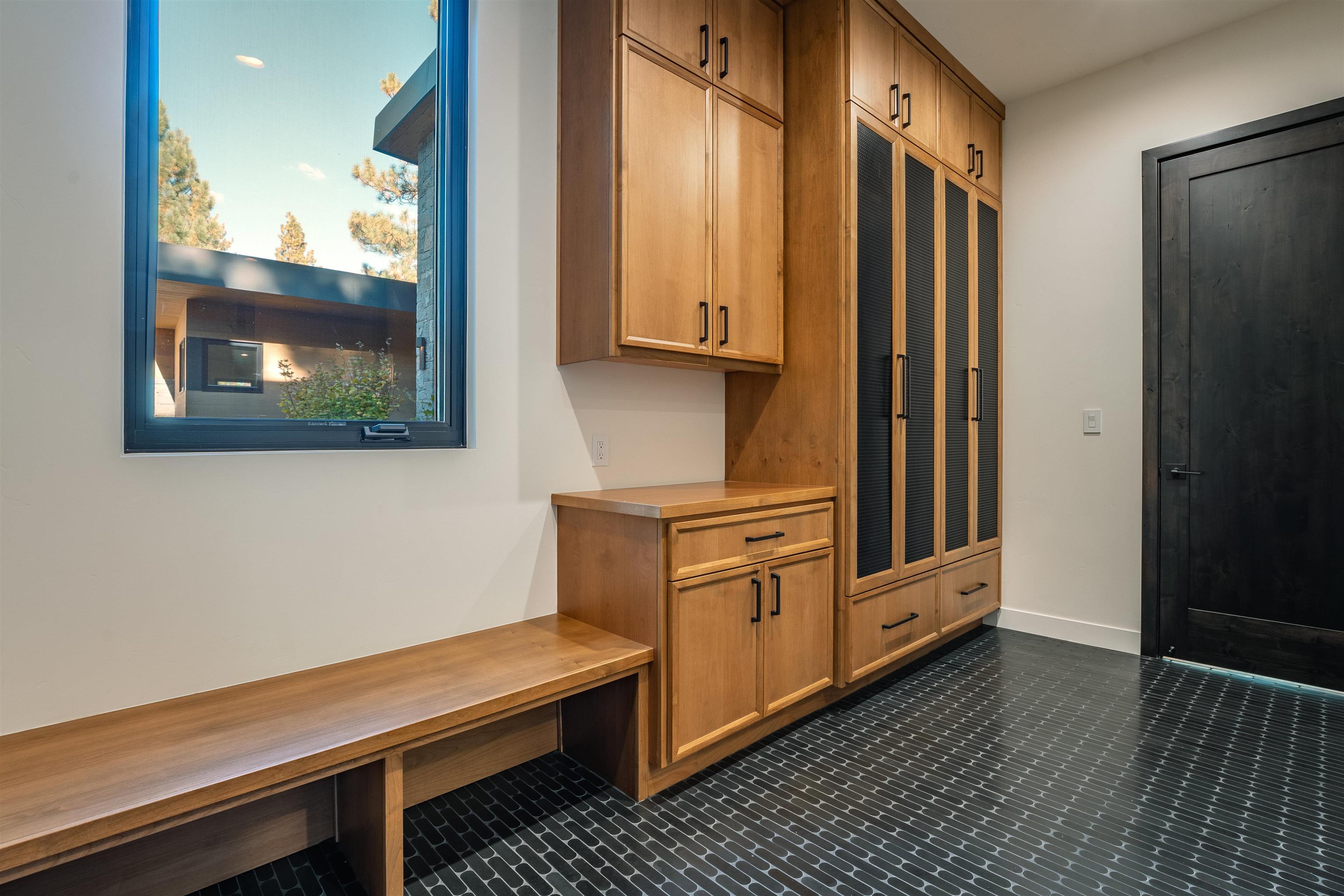9090 Horned Lark Court Truckee, CA 96161 - Photo 25 of 28 a kitchen with granite countertop white cabinets and wooden floor