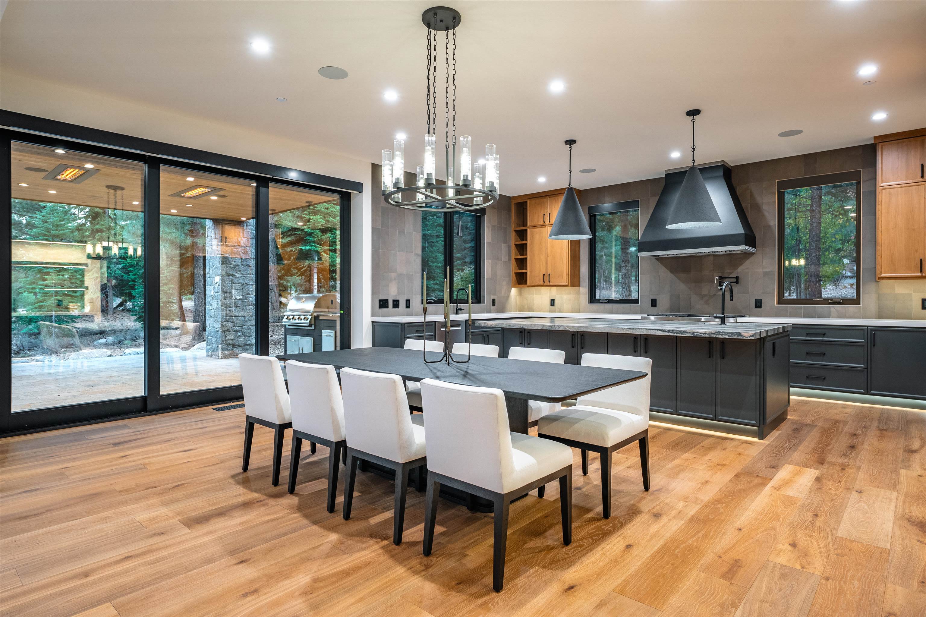 9090 Horned Lark Court Truckee, CA 96161 - Photo 3 of 28 a dining room with wooden floor a chandelier a wooden table and chairs