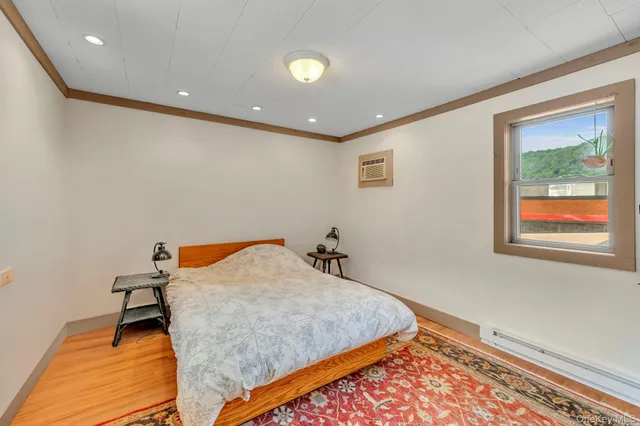 a bedroom with a bed and a painting on the wall