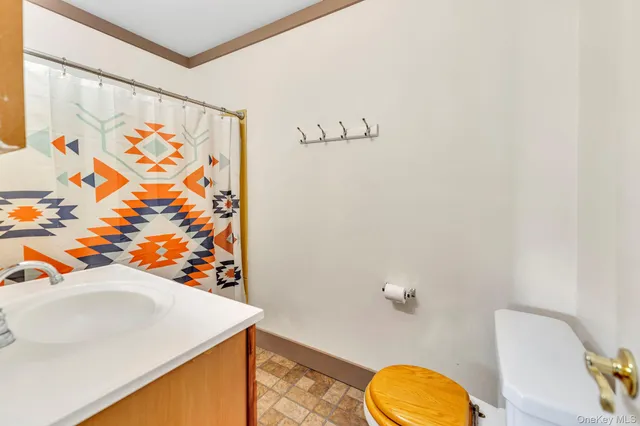 a bathroom with a sink mirror vanity and toilet