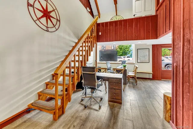 a view of staircase with furniture and a window