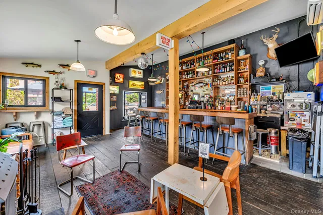 a living room with lots of furniture and clutter