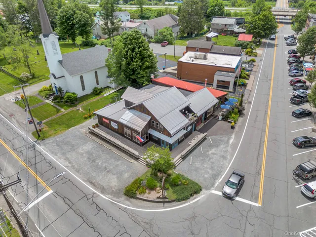 an aerial view of a house with a garden and trees