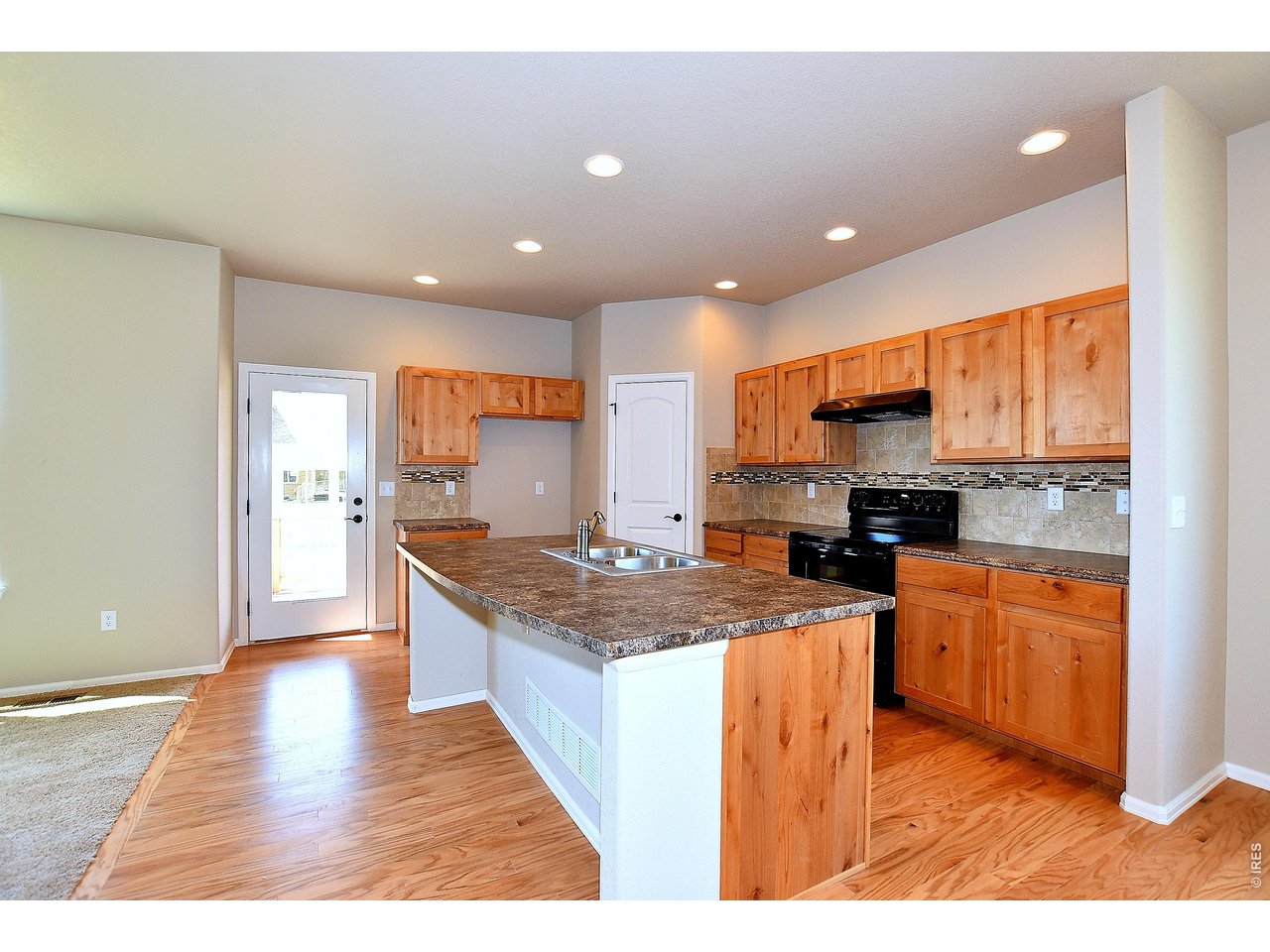 500 85th Avenue Greeley, CO 80634 - Photo 15 of 39 a kitchen with stainless steel appliances granite countertop a stove top oven a sink dishwasher and a refrigerator