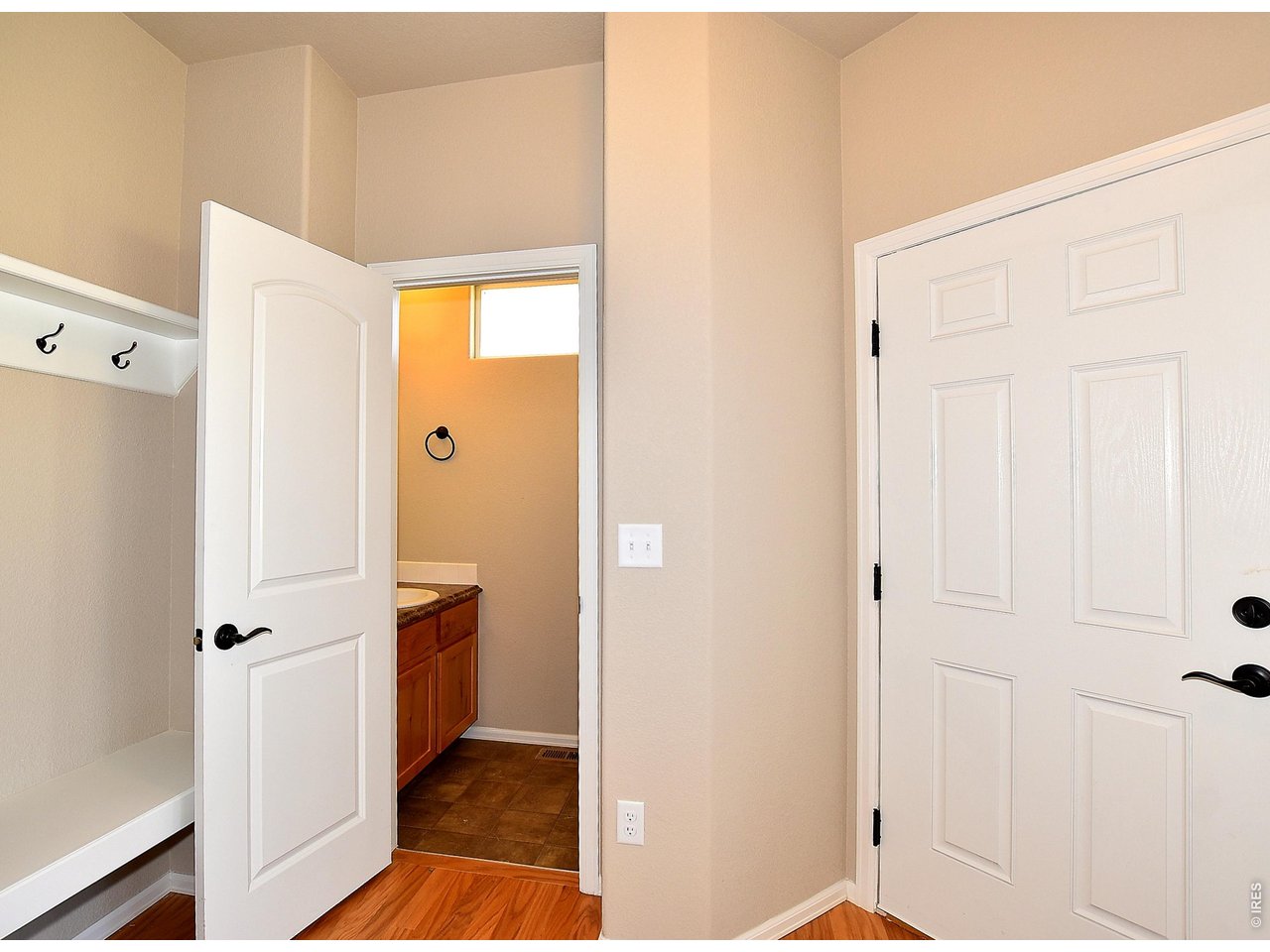 500 85th Avenue Greeley, CO 80634 - Photo 21 of 39 a view of a hallway with wooden floor and a bathroom