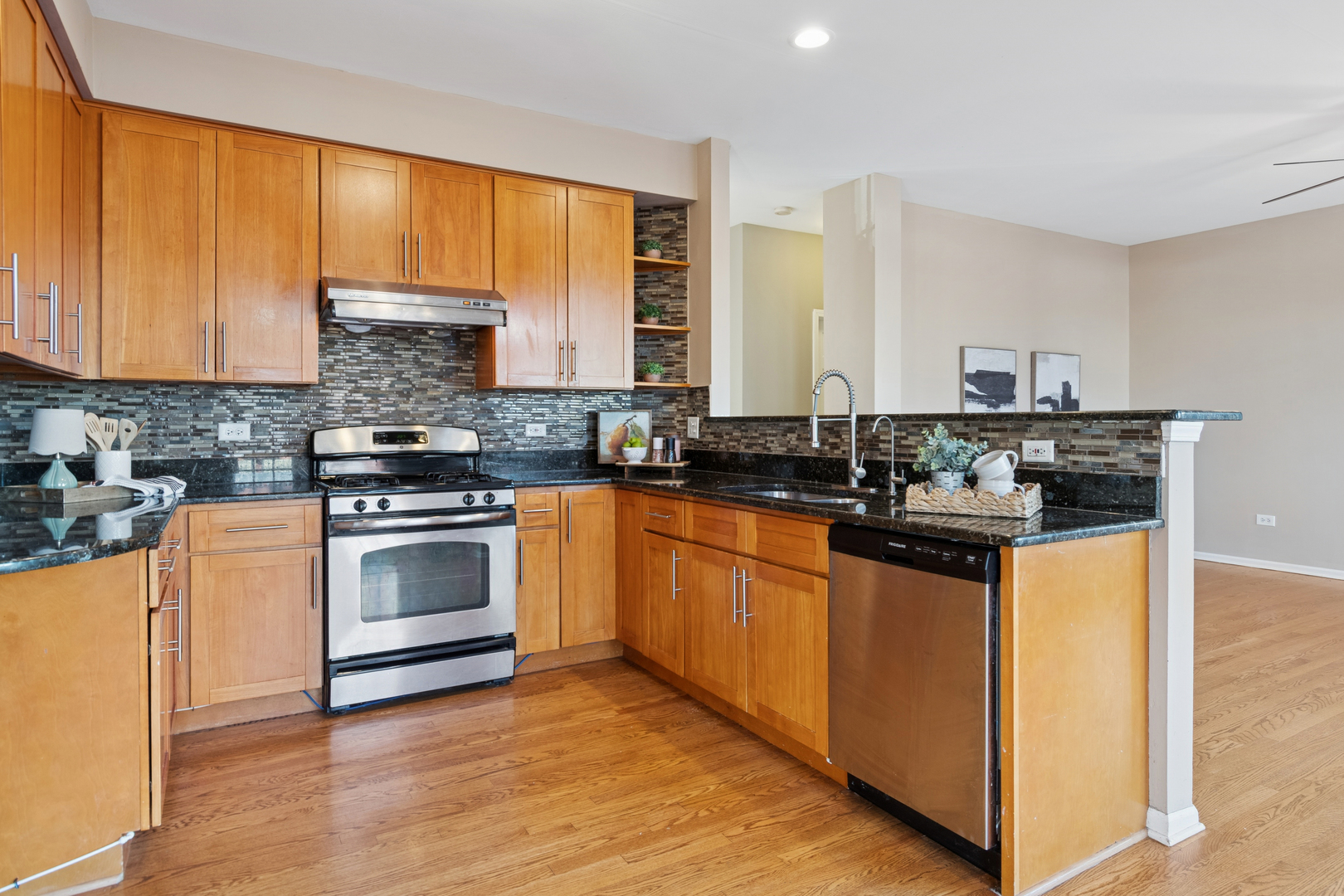 206 Sparrow Lane Bolingbrook, IL 60490 - Photo 6 of 22 a kitchen with stainless steel appliances a stove sink and microwave