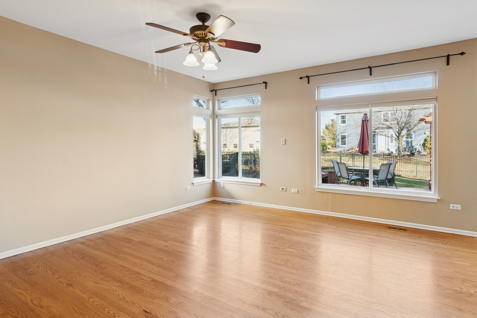 206 Sparrow Lane Bolingbrook, IL 60490 - Photo 8 of 22 a view of an empty room with a window and wooden floor