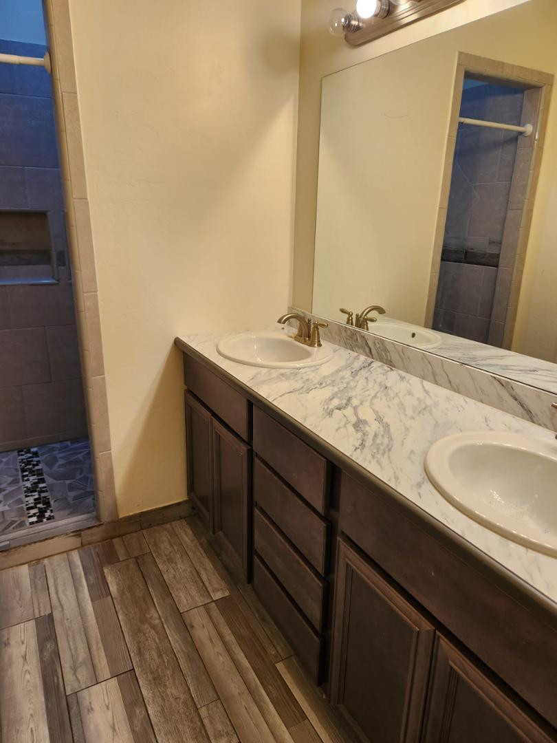 3641 Camino Del Rancho Douglas, AZ 85607 - Photo 16 of 20 a bathroom with a granite countertop sink and a mirror