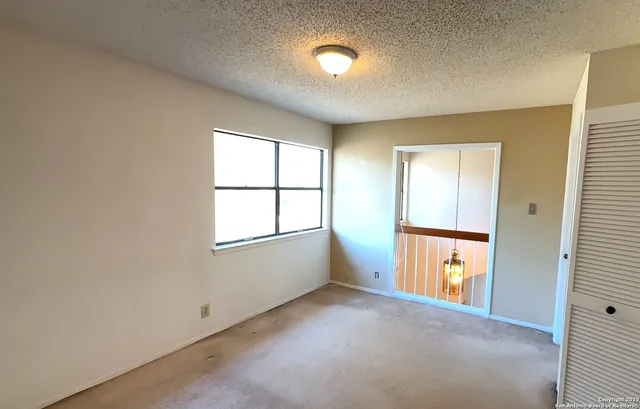 an empty room with windows and closet