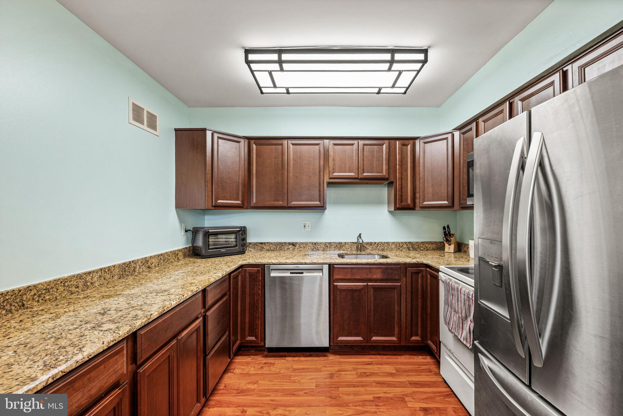 22 Fitzwatertown Road, Unit F4 Willow Grove, PA 19090 - Photo 7 of 20 a kitchen with a sink stove and refrigerator