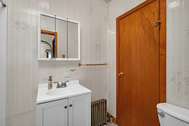 a bathroom with a sink a mirror and a toilet