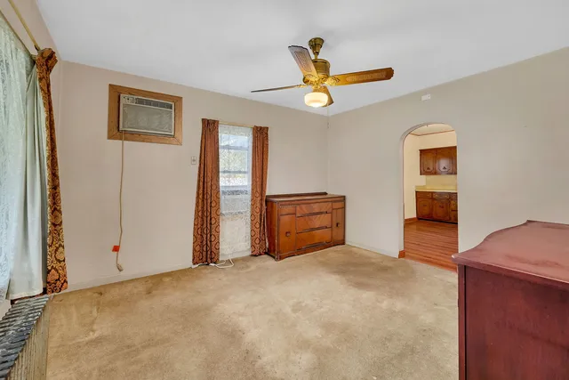 a bedroom with bed and window