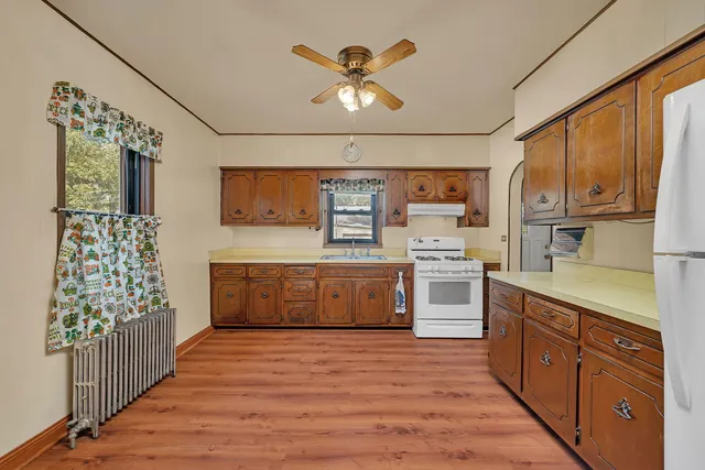 a kitchen with stainless steel appliances granite countertop a stove a sink dishwasher and a refrigerator