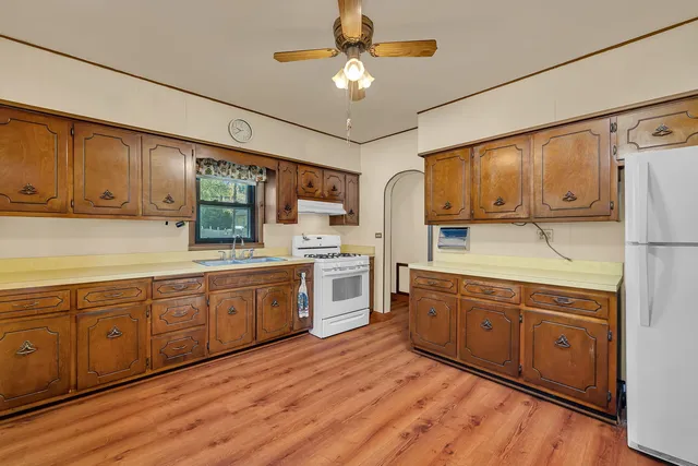 a kitchen with sink cabinets and window