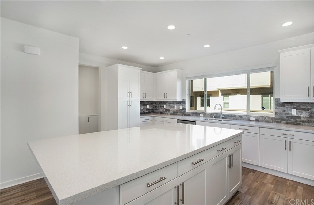 404 Coyote Pass Blanchard, ID 83804 - Photo 4 of 22 a large kitchen with granite countertop a sink and white cabinets