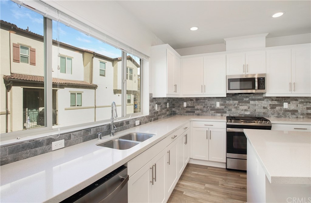 404 Coyote Pass Blanchard, ID 83804 - Photo 5 of 22 a kitchen with a sink stove and microwave