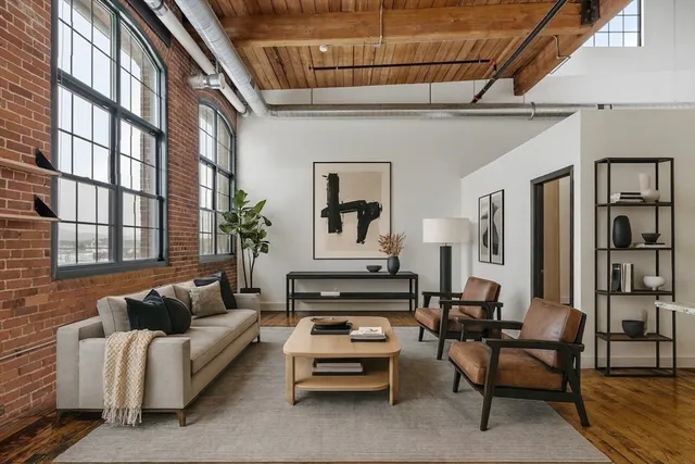a living room with furniture fireplace and a window