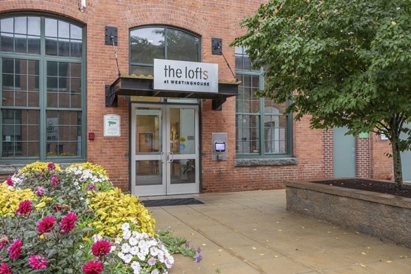 1 Westinghouse Plaza, Unit C334 Boston, MA 02136 - Photo 11 of 13 a front view of a multi story residential apartment building with a yard