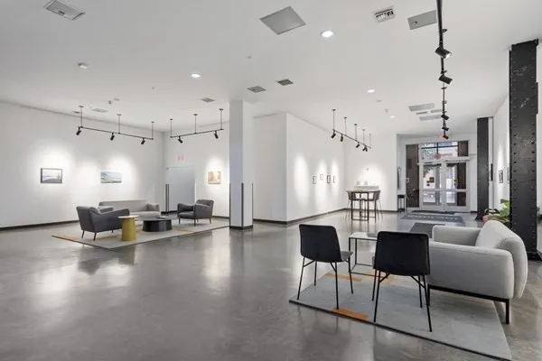 a living room with kitchen island furniture and a chandelier