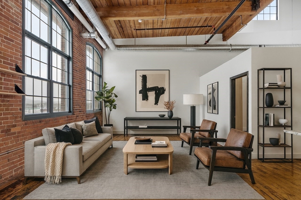 1 Westinghouse Plaza, Unit C334 Boston, MA 02136 - Photo 13 of 13 a living room with furniture fireplace and a window