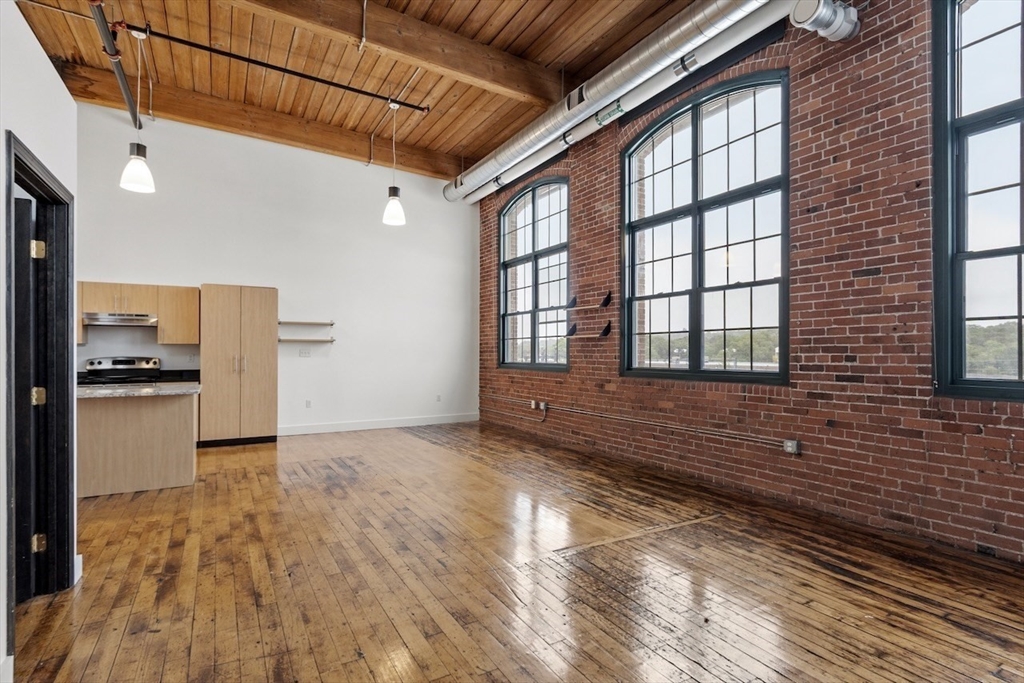 1 Westinghouse Plaza, Unit C334 Boston, MA 02136 - Photo 5 of 13 a view of empty room with wooden floor