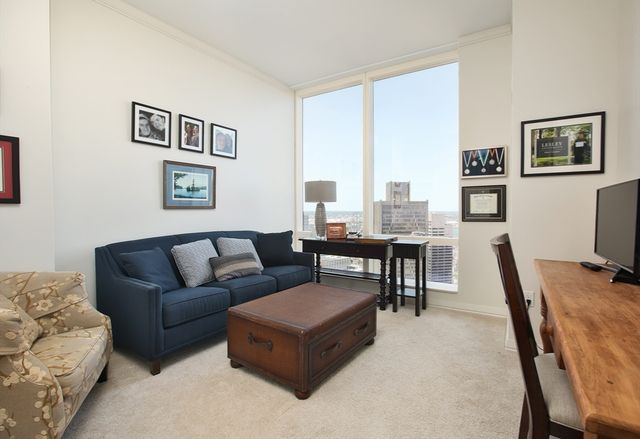 a living room with furniture and large windows