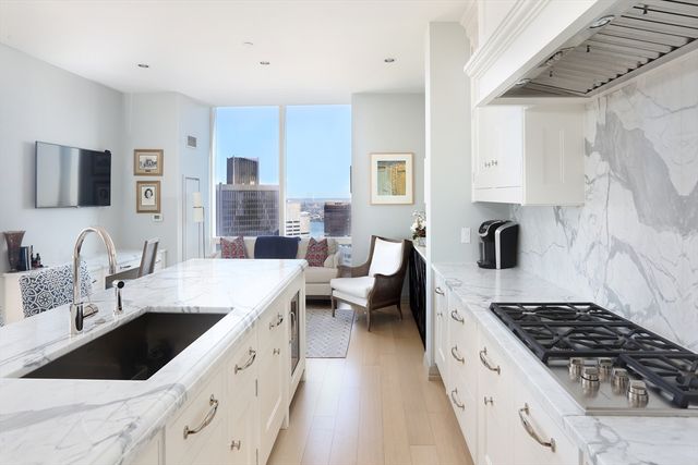 a kitchen with a sink stove and cabinets