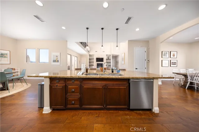 a view of a dining room with furniture a chandelier and wooden floor