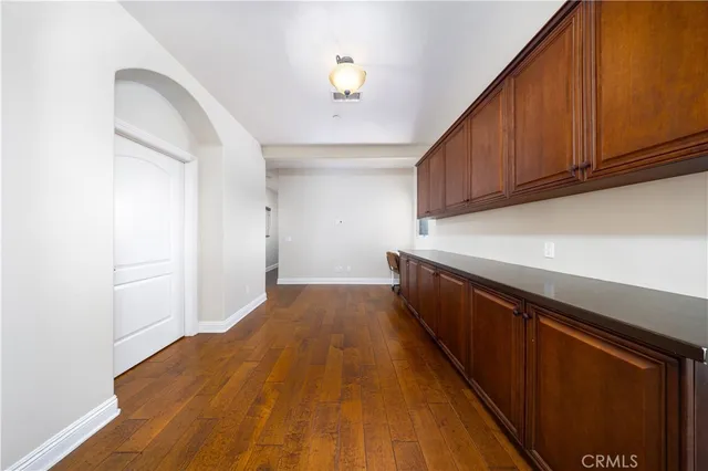 a bathroom with a toilet a sink a mirror and vanity