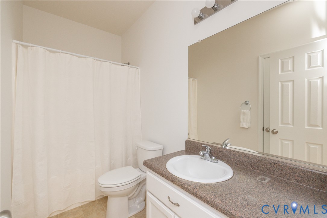 15618 Rowlett Road Chesterfield, VA 23838 - Photo 15 of 29 a bathroom with a granite countertop sink and a mirror