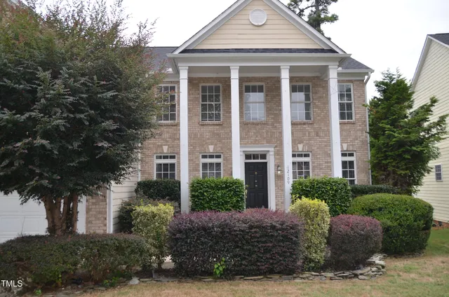 a front view of a house with a garden