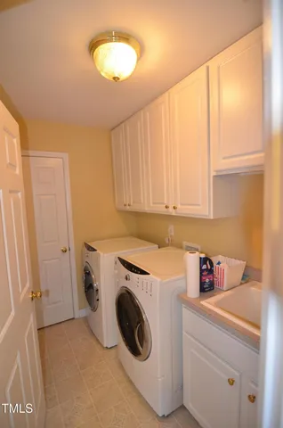 a bedroom with a bed window and chandelier