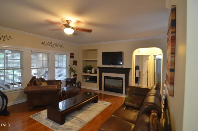a living room with furniture a rug and a window