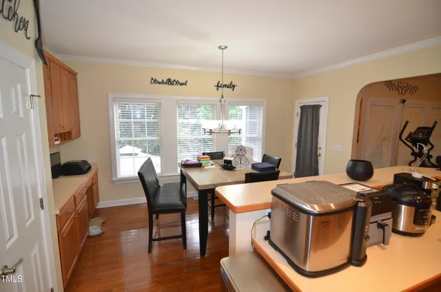 a large kitchen with stainless steel appliances granite countertop a stove a sink dishwasher a microwave oven with cabinets and wooden floor