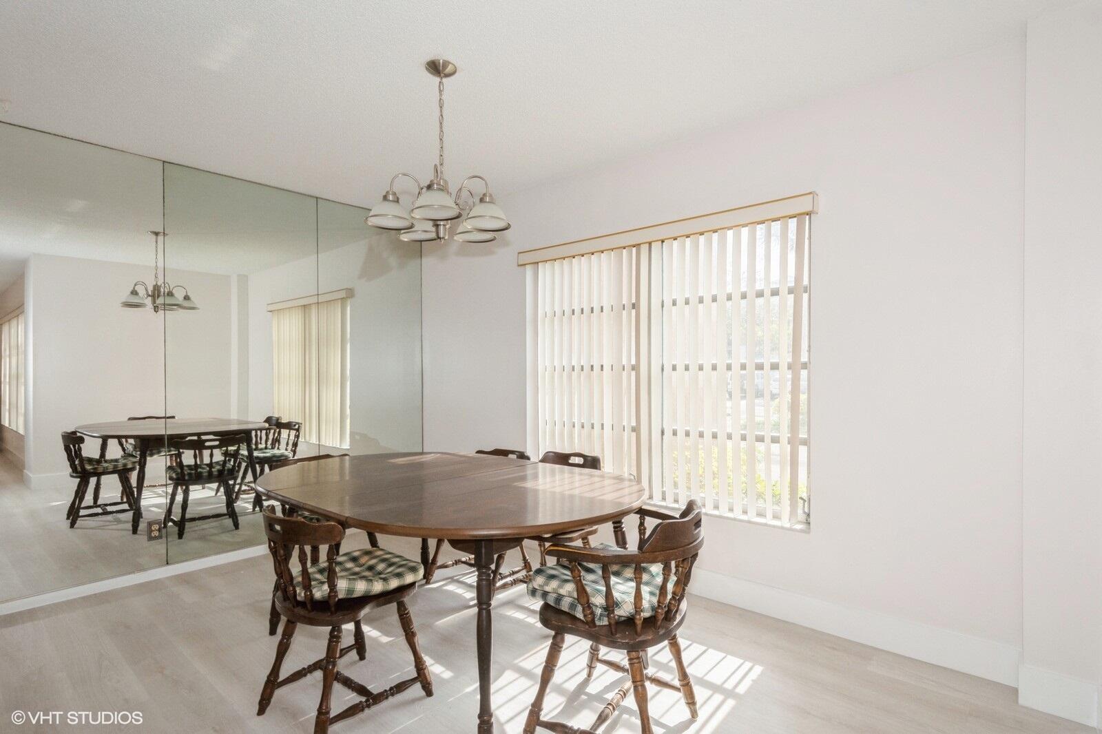 10777 West Sample Road, Unit 101 Coral Springs, FL 33065 - Photo 13 of 36 a dining room with furniture and window