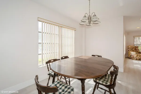 a view of a dining room with furniture and window