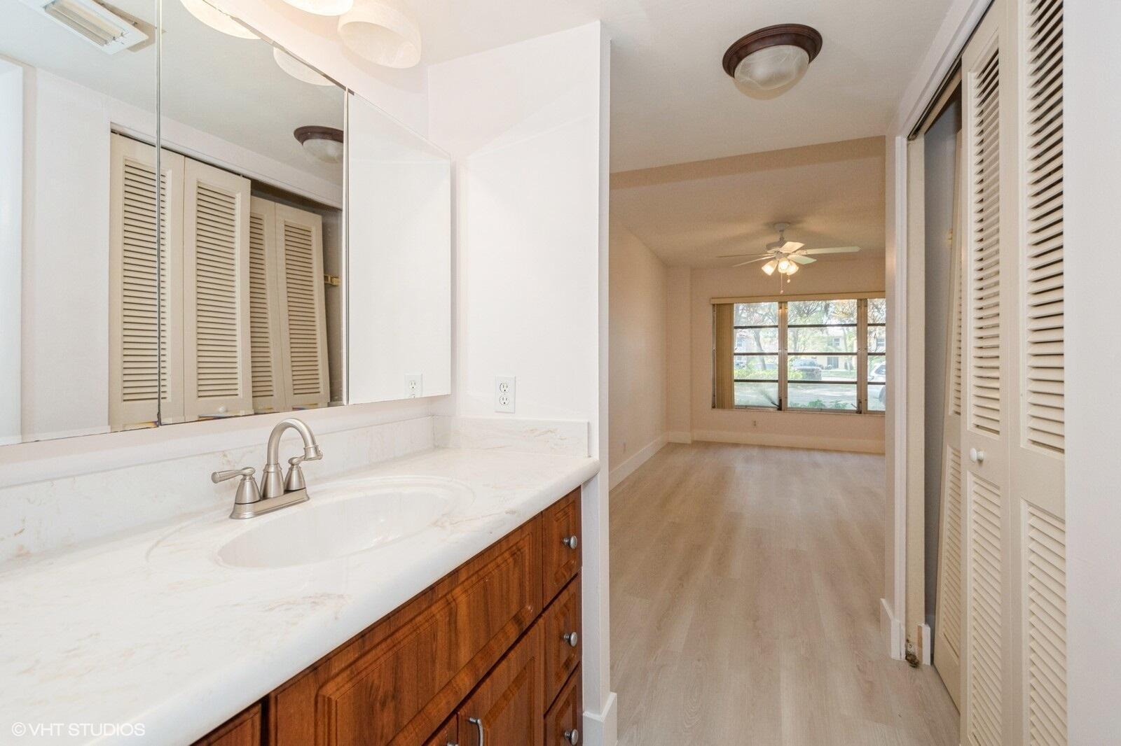 10777 West Sample Road, Unit 101 Coral Springs, FL 33065 - Photo 21 of 36 a bathroom with a sink double vanity and a mirror