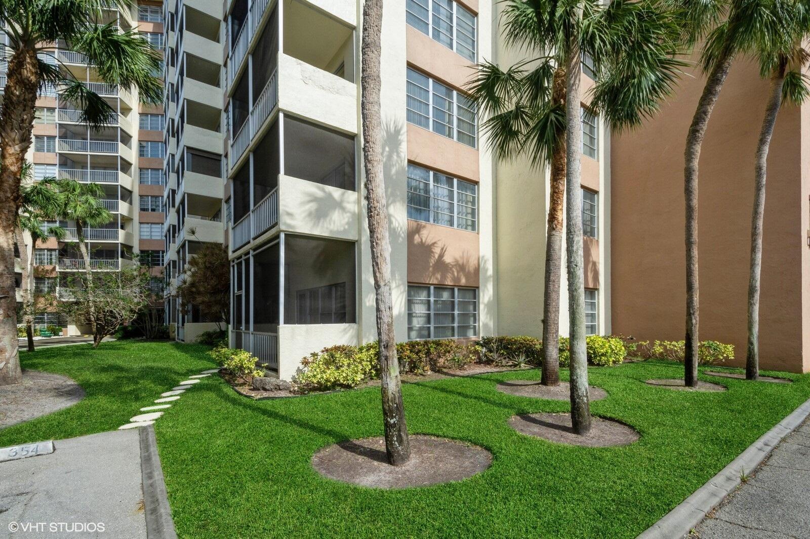 10777 West Sample Road, Unit 101 Coral Springs, FL 33065 - Photo 35 of 36 a front view of multi story residential apartment building with yard and green space